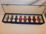 VASES IN A CASE, SET OF 8, THRU THE AGES. APPEARS TO BE MADE OF COPPER, LAC