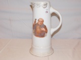 STERLING CHINA WATER PITCHER WITH A MAN HOLDING A GLASS ON THE FRONT, GOLD