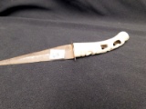 KNIFE WITH A CARVED-BONE HANDLE WITH FACES ON IT.   MEASURES 11