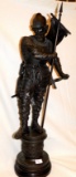 STATUE:  METAL WARRIOR STATUE HOLDING A FLAG & SWORD ON A WOODEN BASE, WEIG