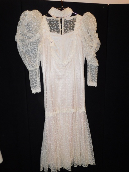 DRESS:    BY LORRIE KABALA; LACE, PUFFY SLEEVES. BUTTON BACK.  14.5"  ACROS