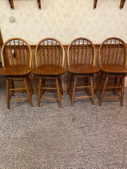 Three oak swivel barstools. Seat height 24 inches.