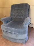 Upholstered blue swivel rocking chair