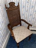 Upholstered caned back chair.