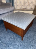Oak ottoman with upholstered lid and storage.