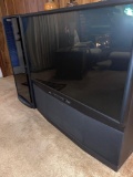 Mitsubishi 54? console TV with matching stereo cabinet.