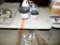 Group of Flooring Adhesive, Furnace Cement & A Box of Paint (Under Table)