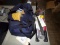 Group of Tools and a Blue Bag with Spark Plugs, Adult Books, And Misc