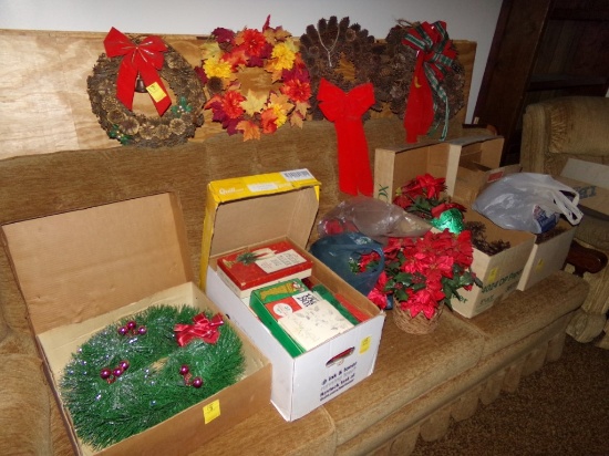 Group of Christmas Decorations on Couch, Including Wreaths, Fake Flowers, O