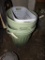 (2) Green Garbage Cans and a Laundry Basket (Garage)