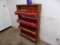 Wooden Display Shelf with Red Storage Bins with Peg Board Hooks in a Few of
