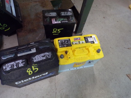 (2) Vehicle Batteries, Both Read 12 V and (1) Lawnmower Battery, Reads 12 V