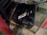 (2) Empty Black Surveyor Level Cases Under the Table (Sm. Den off Kitchen)