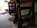 Set of Plastic Adjustable Height Saw Horses Under the Work Bench