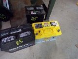 (2) Vehicle Batteries, Both Read 12 V and (1) Lawnmower Battery, Reads 12 V