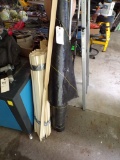 Group of Wooden Stakes and Partial Roll of Site Protector Material (Garage)
