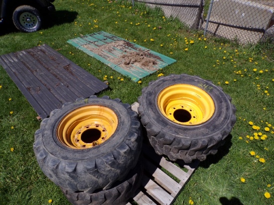 Set Of (4) Used 12-16.5 NHS Skid Steer Tires Mounted On Yellow 8-Lug Wheels