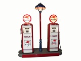 Perfectly restored 1950s Mobil Oil fuel island complete with two original Tokheim 300 gas pumps.