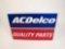 NOS AC Delco Quality Parts single-sided embossed tin automotive garage sign.