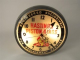 1950s Hastings Piston Rings glass-faced light-up service station clock with neat graphics.