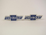 Lot of two 1950s Chevrolet die-cut porcelain bowtie signs designed for mounting to a larger Chevrole