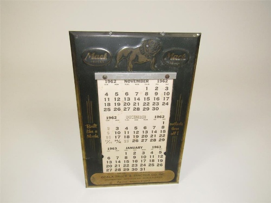 1950s Mack Trucks embossed metal dealership calendar with a 1962 calendar pad.