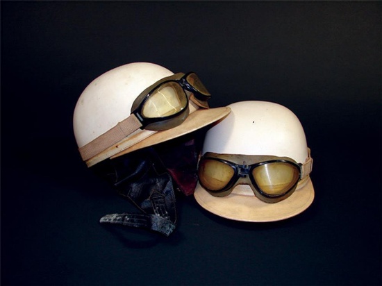 Neat Pair of 1950s Grand Prix race helmets with goggles attached.
