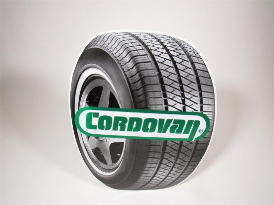 Vintage Cordovan Tires single-sided die-cut tire-shaped tin sign.