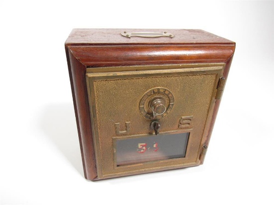 Circa 1920s U.S. Postal Service combination wooden mailbox with glass window.