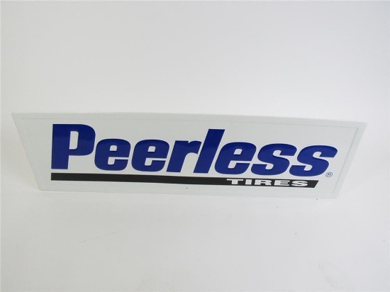 NOS Peerless Tires single-sided self-framed embossed tin automotive garage sign.