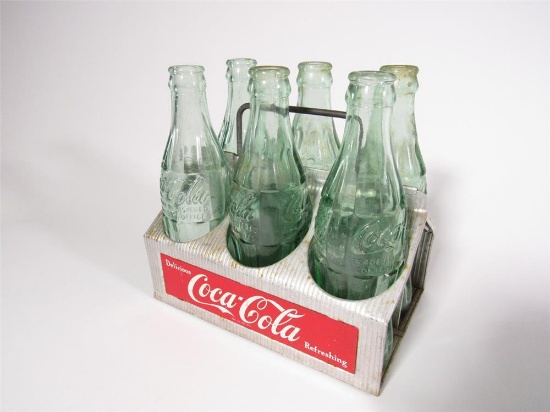 Circa 1950s Drink Coca-Cola aluminum six-pack carrier with six period Coca-Cola glass bottles.