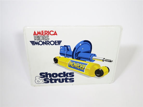 VINTAGE MONROE SHOCKS AND STRUTS SINGLE-SIDED EMBOSSED TIN GARAGE SIGN WITH GRAPHICS.