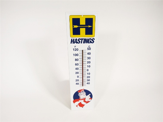 NOS HASTINGS PISTON RINGS VERTICAL TIN SERVICE STATION THERMOMETER WITH HASTINGS MAN LOGO.