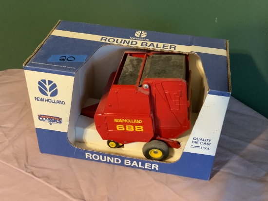 New Holand 688 Round Baler with bale in it NIB