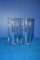 CRATE OF APPROX 20 CLEAR GLASS VASES