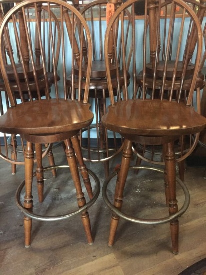 FOUR WOODEN SWIVEL BAR STOOLS WITH METAL FOOT RING,