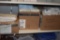 GOWNS AND ROLLS OF PAPER ON LOWER SHELF