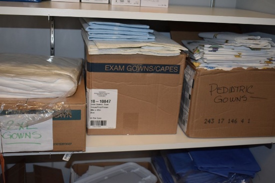 GOWNS AND ROLLS OF PAPER ON LOWER SHELF