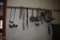 ASSORTED LADLES AND MISC. UTENSILS HANGING FROM HOOKS