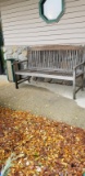 OUTSIDE WOODEN BENCH AND STONE ASHTRAY
