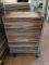 APPROX. 75 ALUMINUM BAKERY TRAYS ON ROLLER BASE