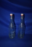 (2) GLASS GEYER FRERES BOTTLES W/ATTACHED LIDS