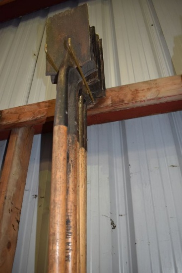 LONG HANDLED SHINGLE SCRAPERS ON HOOKS AND ON FLOOR BENEATH