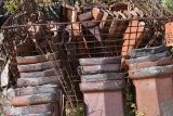 COPING CAPS IN WIRE MESH CRATE AND LEANING AGAINST CRATE