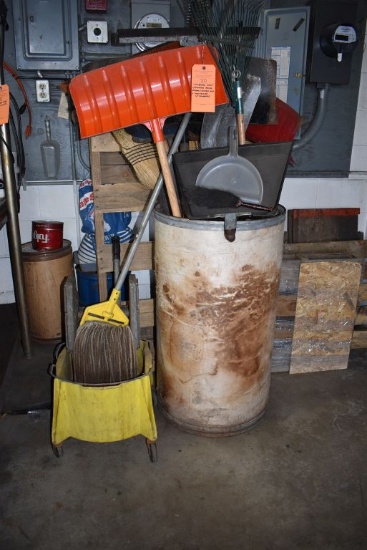 CARDBOARD DRUM WITH ASSORTED RAKES, BROOMS, SHOVELS, ETC.