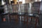 (4) RATTAN STYLE CHAIRS, BLACK PADDED SEATS,