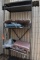 GRAY METAL SHELVING UNIT WITH CONTENTS - ASSORTED CUSHIONS,
