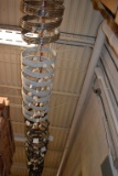 LARGE ASSORTMENT OF WHEELS HANGING FROM CEILING HOOKS