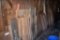 ASSORTED LUMBER ALONG GARAGE WALL, VERTICALLY