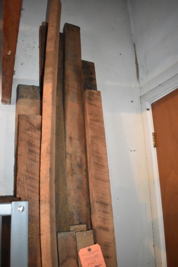 ROUGH SAW LUMBER LEANING AGAINST THIS WALL